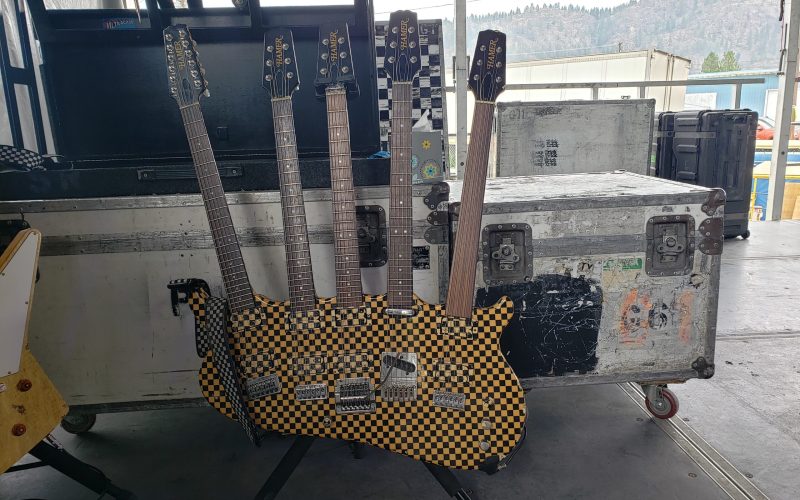 Cheap Trick’s iconic 5-neck guitar being played during a live performance.