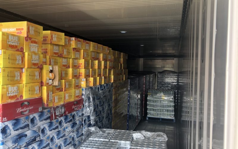 Festival-goers enjoying cold beers at the Canada Rock Fest Beer Garden under the summer sun.